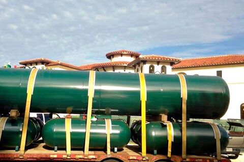 Commercial propane tanks loaded on an Elite Gas trailer.